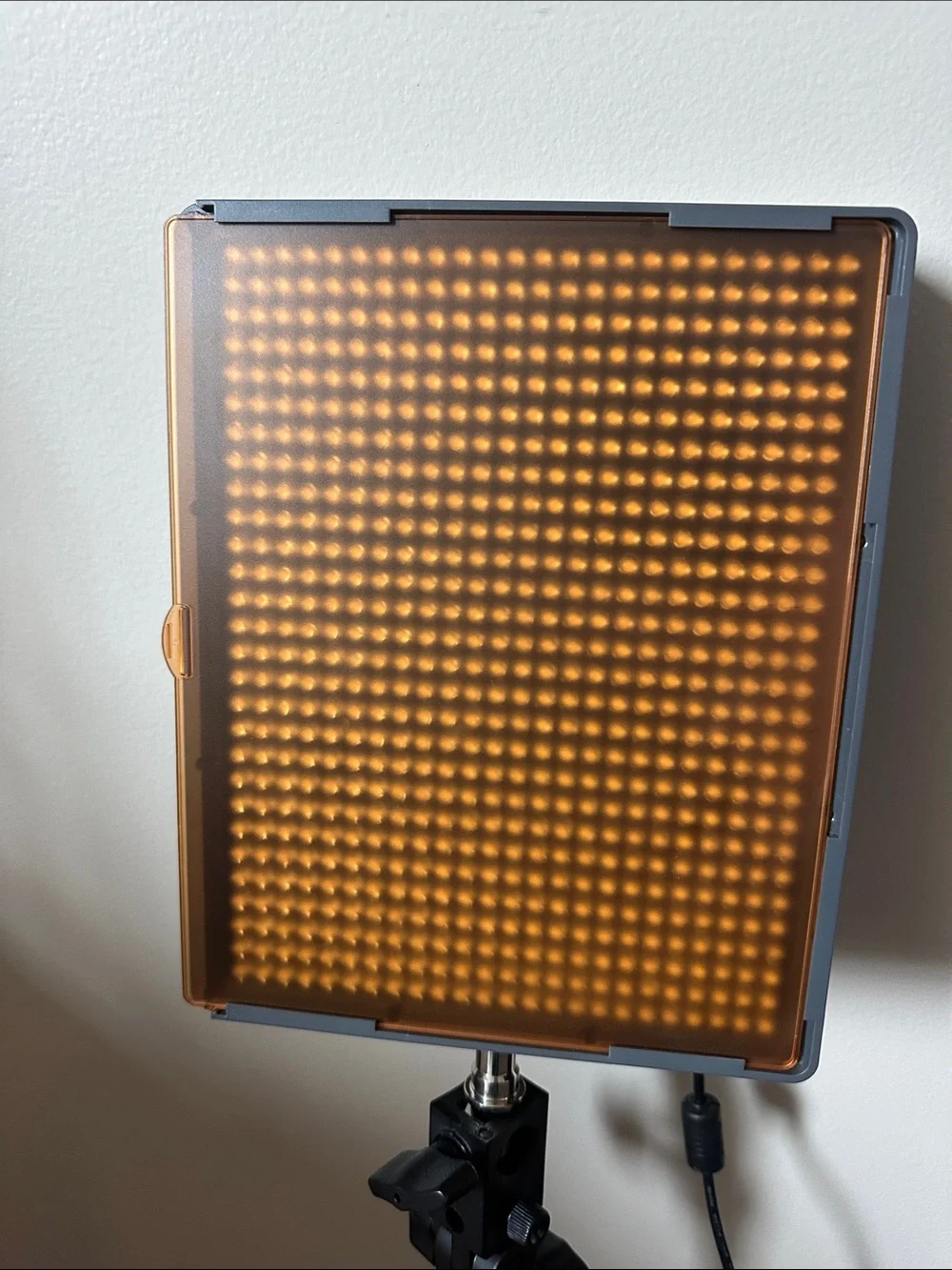 Aputure Amaran HR672W LED Video Light Panel with stand/holder and orange filter.